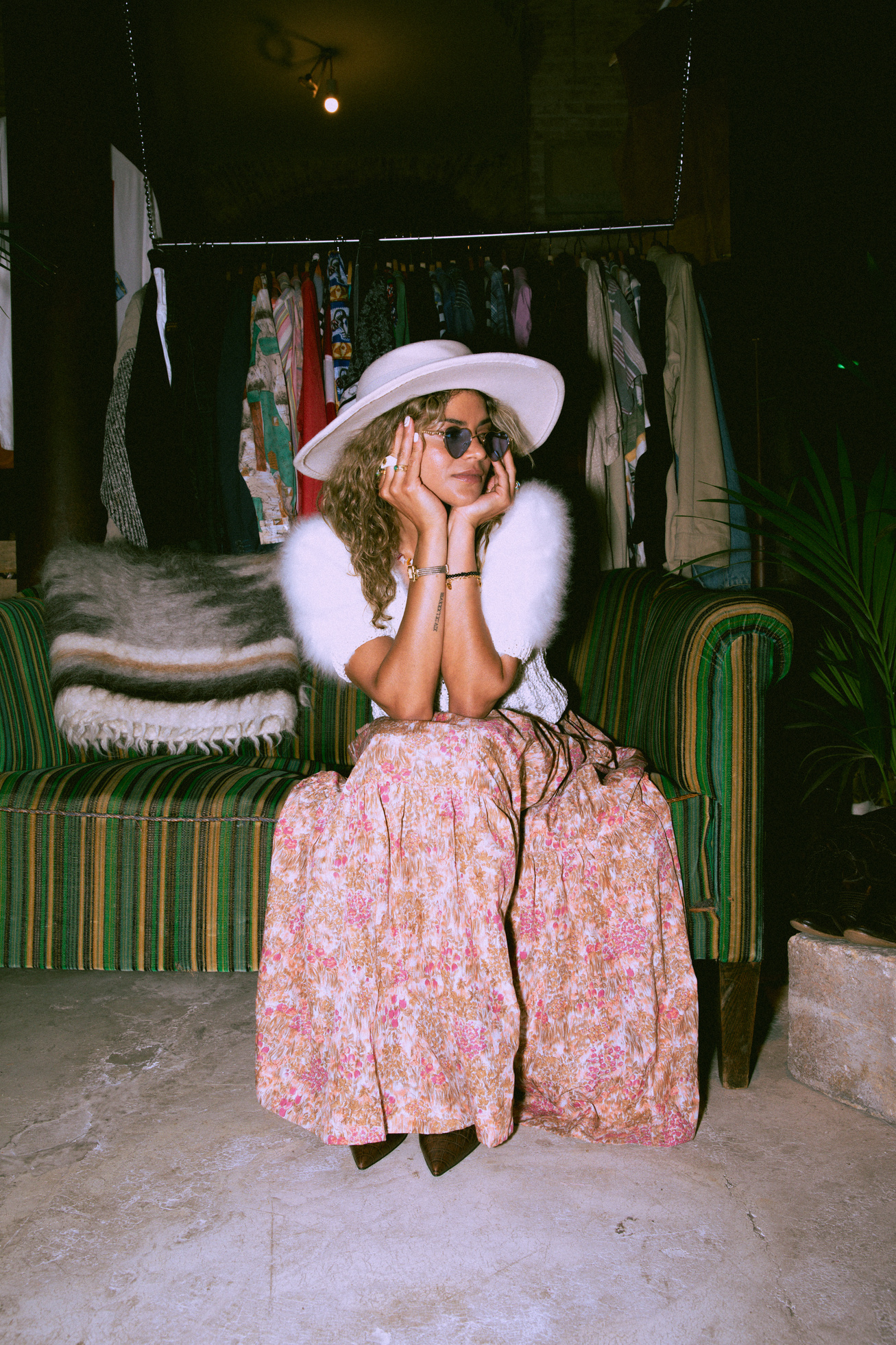 an attractive model sitting on a couch